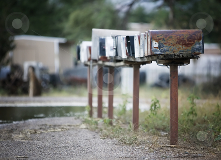 To use this stock image in your creative project, please select the size you need over to the right and click the "Add to Cart" button.
Your downloaded image will come with the Cutcaster watermark removed so don’t worry about the watermark you see on this page. Rural Mailboxes stock photo, Rural mailboxes in a row alongside a country road. by Scott Griessel
