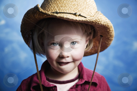 To use this stock image in your creative project, please select the size you need over to the right and click the "Add to Cart" button.
Your downloaded image will come with the Cutcaster watermark removed so don’t worry about the watermark you see on this page. Little girl in front of blue wall with a cowboy hat stock photo, Little girl in front of blue wall wearing a cowboy hat with her tongue out by Scott Griessel