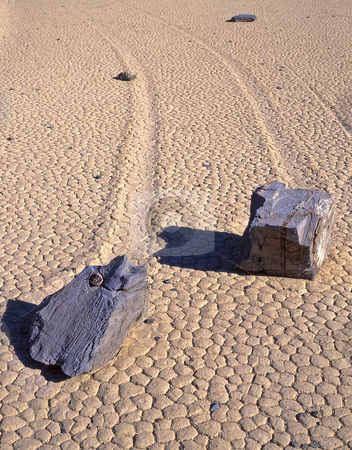 To use this stock image in your creative project, please select the size you need over to the right and click the "Add to Cart" button.
Your downloaded image will come with the Cutcaster watermark removed so don’t worry about the watermark you see on this page. Double Rock Trails 3 stock photo, Two rocks and their trails on the Racetrack Playa in Death Valley National Park, California. by Mike Norton