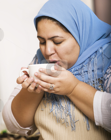 To use this stock image in your creative project, please select the size you need over to the right and click the "Add to Cart" button.
Your downloaded image will come with the Cutcaster watermark removed so don’t worry about the watermark you see on this page. Muslim Woman Drinking Coffee stock photo, Muslim woman wearing a head scarf drinking coffee by Scott Griessel