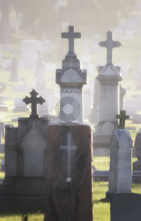 To use this stock image in your creative project, please select the size you need over to the right and click the "Add to Cart" button.
Your downloaded image will come with the Cutcaster watermark removed so don’t worry about the watermark you see on this page. Misty Cemetery stock photo, Misty cemetary at dawn featuring headstones and memorials. All names have been obscured. by Scott Griessel