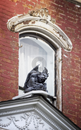 To use this stock image in your creative project, please select the size you need over to the right and click the "Add to Cart" button.
Your downloaded image will come with the Cutcaster watermark removed so don’t worry about the watermark you see on this page. Gargoyle on on Old House stock photo, Gargoyle perched in front of a window on a dilapidated brick house. by Scott Griessel