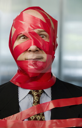 To use this stock image in your creative project, please select the size you need over to the right and click the "Add to Cart" button.
Your downloaded image will come with the Cutcaster watermark removed so don’t worry about the watermark you see on this page. Red Tape stock photo, Businessman wrapped in red tape by Scott Griessel