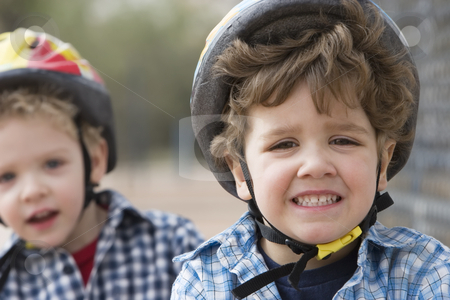 To use this stock image in your creative project, please select the size you need over to the right and click the "Add to Cart" button.
Your downloaded image will come with the Cutcaster watermark removed so don’t worry about the watermark you see on this page. Little boys in a bicycle helmets stock photo, Two little boys in bicycle helmets - one boy looks concerned by Scott Griessel