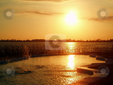 To use this stock image in your creative project, please select the size you need over to the right and click the "Add to Cart" button.
Your downloaded image will come with the Cutcaster watermark removed so don’t worry about the watermark you see on this page. Sunset stock photo, Sunset over a lake nice orange tones. by Lucy Clark