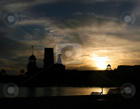 To use this stock image in your creative project, please select the size you need over to the right and click the "Add to Cart" button.
Your downloaded image will come with the Cutcaster watermark removed so don’t worry about the watermark you see on this page. Silhouette Sunset stock photo, The silhouettes of a hotel at sunset. by Lucy Clark