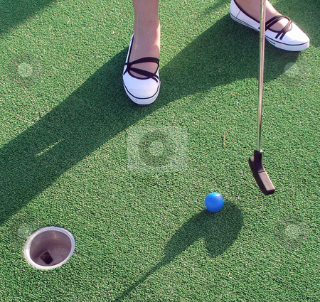 To use this stock image in your creative project, please select the size you need over to the right and click the "Add to Cart" button.
Your downloaded image will come with the Cutcaster watermark removed so don’t worry about the watermark you see on this page. Adventure Golf stock photo, Playing Adventure Golf, feet, club, ball and hole. by Lucy Clark
