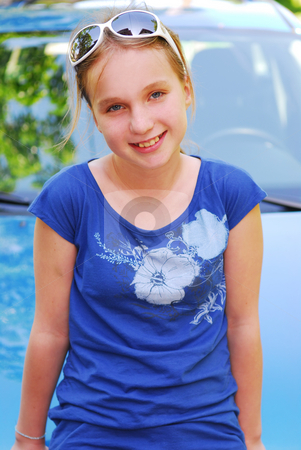To use this stock image in your creative project, please select the size you need over to the right and click the "Add to Cart" button.
Your downloaded image will come with the Cutcaster watermark removed so don’t worry about the watermark you see on this page. Girl portrait stock photo, Portrait of a young girl in sunglasses sitting on a car hood by Elena Elisseeva