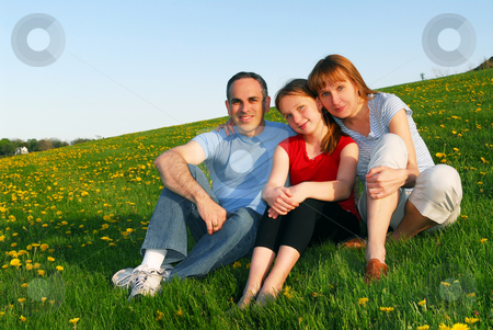 To use this stock image in your creative project, please select the size you need over to the right and click the "Add to Cart" button.
Your downloaded image will come with the Cutcaster watermark removed so don’t worry about the watermark you see on this page. Family portrait stock photo, Portrait of a happy family of three on blooming summermedow by Elena Elisseeva