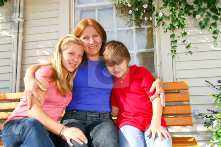 To use this stock image in your creative project, please select the size you need over to the right and click the "Add to Cart" button.
Your downloaded image will come with the Cutcaster watermark removed so don’t worry about the watermark you see on this page. Family at a house stock photo, Portrait of a smiling family - mother and children - in front of the house by Elena Elisseeva