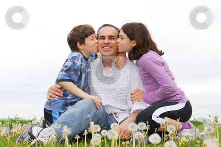 To use this stock image in your creative project, please select the size you need over to the right and click the "Add to Cart" button.
Your downloaded image will come with the Cutcaster watermark removed so don’t worry about the watermark you see on this page. Happy family stock photo, Grateful children giving their father a kiss by Elena Elisseeva