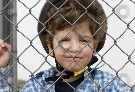 To use this stock image in your creative project, please select the size you need over to the right and click the "Add to Cart" button.
Your downloaded image will come with the Cutcaster watermark removed so don’t worry about the watermark you see on this page. Little boy in a bicycle helmet stock photo, A little boy in a bicycle helmet behind chain link by Scott Griessel