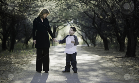 To use this stock image in your creative project, please select the size you need over to the right and click the "Add to Cart" button.
Your downloaded image will come with the Cutcaster watermark removed so don’t worry about the watermark you see on this page. Boy with Mother stock photo, Young boy with his mother on a tree-lined path. by Scott Griessel