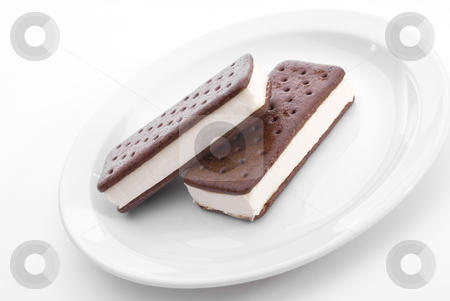 To use this stock image in your creative project, please select the size you need over to the right and click the "Add to Cart" button.
Your downloaded image will come with the Cutcaster watermark removed so don’t worry about the watermark you see on this page. Delicious Ice Cream Sandwiches stock photo, Two tasty frozen icce cream snack sandwich bars on a white plate by Vince Clements