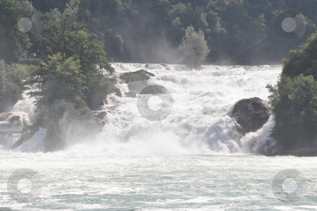 To use this stock image in your creative project, please select the size you need over to the right and click the "Add to Cart" button.
Your downloaded image will come with the Cutcaster watermark removed so don’t worry about the watermark you see on this page. Rhine Falls in Schaffhausen stock photo, Rhine Falls in Schaffhausen at the border of Germany and Switzerland by Ritu Jethani