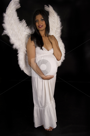 https://watermarked.cutcaster.com/cutcaster-photo-800888446-A-beautiful-pregnant-Indian-woman-in-white-dress-and-angel-wings-smiling-on-black-backdrop.jpg