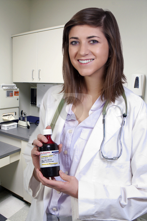 To use this stock image in your creative project, please select the size you need over to the right and click the "Add to Cart" button.
Your downloaded image will come with the Cutcaster watermark removed so don’t worry about the watermark you see on this page. Woman Doctor stock photo, A woman doctor holding a bottle of prescription medication by Robert Byron