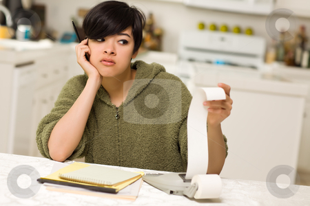 To use this stock image in your creative project, please select the size you need over to the right and click the "Add to Cart" button.
Your downloaded image will come with the Cutcaster watermark removed so don’t worry about the watermark you see on this page. Multi-ethnic Young Woman Agonizing Over Financial Calculations stock photo, Multi-ethnic Young Woman Agonizing Over Financial Calculations in Her Kitchen. by Andy Dean