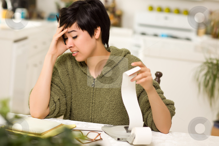 To use this stock image in your creative project, please select the size you need over to the right and click the "Add to Cart" button.
Your downloaded image will come with the Cutcaster watermark removed so don’t worry about the watermark you see on this page. Multi-ethnic Young Woman Agonizing Over Financial Calculations stock photo, Multi-ethnic Young Woman Agonizing Over Financial Calculations in Her Kitchen. by Andy Dean