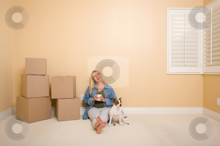 To use this stock image in your creative project, please select the size you need over to the right and click the "Add to Cart" button.
Your downloaded image will come with the Cutcaster watermark removed so don’t worry about the watermark you see on this page. Relaxing Woman and Dog Next to Boxes on Floor stock photo, Pretty Woman Sitting on Floor with Cup Next to Moving Boxes and Dog in Empty Room. by Andy Dean