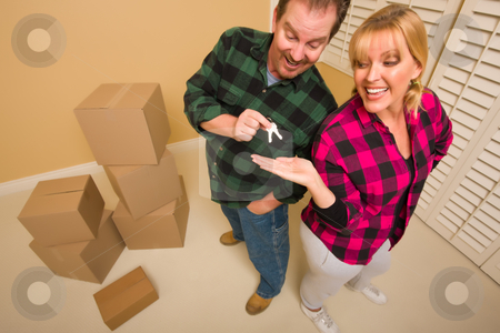 To use this stock image in your creative project, please select the size you need over to the right and click the "Add to Cart" button.
Your downloaded image will come with the Cutcaster watermark removed so don’t worry about the watermark you see on this page. Goofy Excited Man Handing Keys to Smiling Wife stock photo, Goofy Excited Man Handing Keys to Smiling Wife in Room with Packed Boxes. by Andy Dean