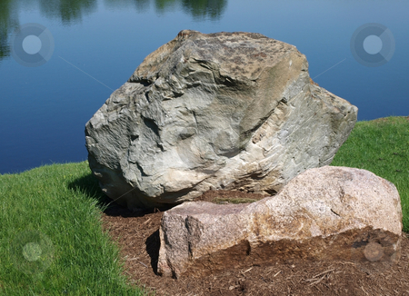 To use this stock image in your creative project, please select the size you need over to the right and click the "Add to Cart" button.
Your downloaded image will come with the Cutcaster watermark removed so don’t worry about the watermark you see on this page. Boulder stock photo, Large Boulder with a lake background by Barb Hodanbosi