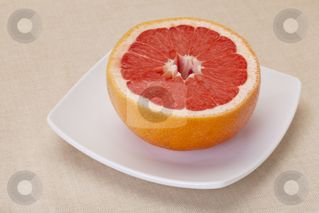 To use this stock image in your creative project, please select the size you need over to the right and click the "Add to Cart" button.
Your downloaded image will come with the Cutcaster watermark removed so don’t worry about the watermark you see on this page. Cut red grapefruit stock photo, half of red grapefruit on white square bowl against tablecloth by Marek Uliasz