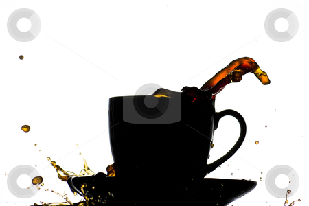 photo, a silhouette of a coffe cup spilling and splashing coffee
