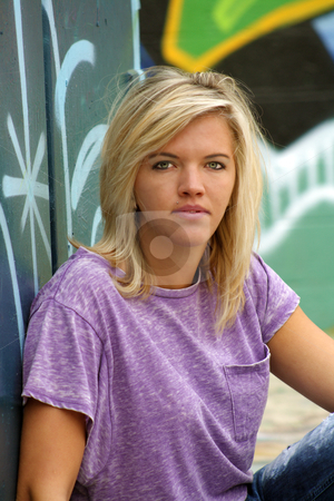 To use this stock image in your creative project, please select the size you need over to the right and click the "Add to Cart" button.
Your downloaded image will come with the Cutcaster watermark removed so don’t worry about the watermark you see on this page. Attractive Blonde with Graffiti (1) stock photo, A lovely young blonde leans against a graffiti-covered garbage dumpster with a graffiti-covered wall behind her. by Carl Stewart