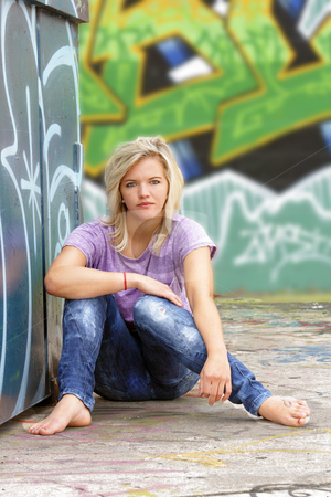 To use this stock image in your creative project, please select the size you need over to the right and click the "Add to Cart" button.
Your downloaded image will come with the Cutcaster watermark removed so don’t worry about the watermark you see on this page. Attractive Blonde with Graffiti (3) stock photo, A lovely young blonde leans against a graffiti-covered garbage dumpster with a graffiti-covered wall behind her. by Carl Stewart
