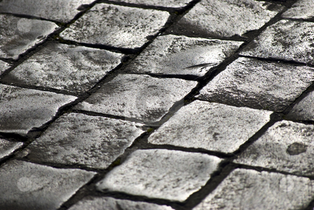 To use this stock image in your creative project, please select the size you need over to the right and click the "Add to Cart" button.
Your downloaded image will come with the Cutcaster watermark removed so don’t worry about the watermark you see on this page. Cobblestones stock photo, pavement of grey old cobblestones shining in the sunlight by Juliane Jacobs