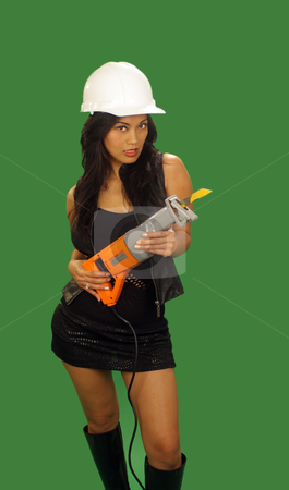 To use this stock image in your creative project, please select the size you need over to the right and click the "Add to Cart" button.
Your downloaded image will come with the Cutcaster watermark removed so don’t worry about the watermark you see on this page. Beautiful Asian Female Construction Worker (1) stock photo, A lovely young and fashionable Indonesian model with long, luscious black hair, holds a reciprocating saw, isolated on a plain green background. by Carl Stewart