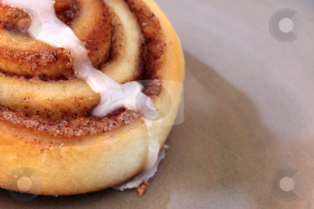To use this stock image in your creative project, please select the size you need over to the right and click the "Add to Cart" button.
Your downloaded image will come with the Cutcaster watermark removed so don’t worry about the watermark you see on this page. Yummy Cinnamon Bun stock photo, A cinnamon bun sitting on a plate. by Chris Hill