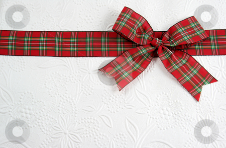 To use this stock image in your creative project, please select the size you need over to the right and click the "Add to Cart" button.
Your downloaded image will come with the Cutcaster watermark removed so don’t worry about the watermark you see on this page. Holiday Plaid Bow stock photo, A plaid christmas bow on decorative white paper.
by Chris Hill