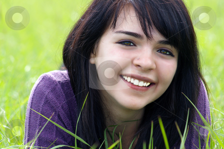 To use this stock image in your creative project, please select the size you need over to the right and click the "Add to Cart" button.
Your downloaded image will come with the Cutcaster watermark removed so don’t worry about the watermark you see on this page. Beautiful Brunette in a Grassy Field (3) stock photo, Close-up of a lovely young brunette with a bright, warm smile lying in a field of tall green grass. by Carl Stewart