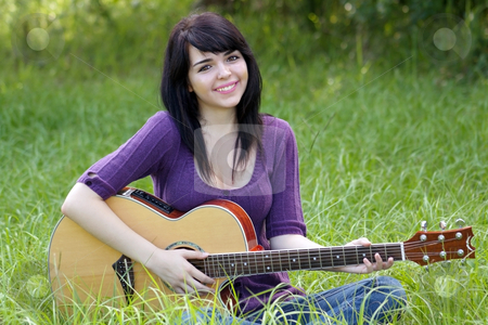 To use this stock image in your creative project, please select the size you need over to the right and click the "Add to Cart" button.
Your downloaded image will come with the Cutcaster watermark removed so don’t worry about the watermark you see on this page. Beautiful Brunette Outdoors with a Guitar (2) stock photo, A lovely young brunette sits in a field of tall green grass with her acoustic guitar, looking directly at the camera. by Carl Stewart