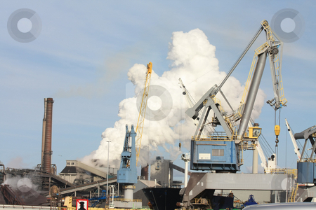 To use this stock image in your creative project, please select the size you need over to the right and click the "Add to Cart" button.
Your downloaded image will come with the Cutcaster watermark removed so don’t worry about the watermark you see on this page. Heavy Industry stock photo, Industrial area with heavy equipment and smoking chimney by Porto Sabbia