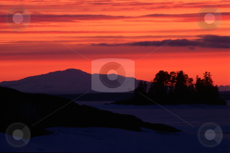 To use this stock image in your creative project, please select the size you need over to the right and click the "Add to Cart" button.
Your downloaded image will come with the Cutcaster watermark removed so don’t worry about the watermark you see on this page. Sunset/sunrise stock photo, Sunset / sunrise in winter.Red sky and snow mountain by Ingvar Bjork