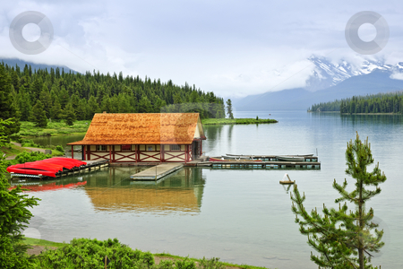 To use this stock image in your creative project, please select the size you need over to the right and click the "Add to Cart" button.
Your downloaded image will come with the Cutcaster watermark removed so don’t worry about the watermark you see on this page. Boathouse on mountain lake stock photo, Canoes at boathouse on Maligne Lake in Jasper National Park, Canada by Elena Elisseeva
