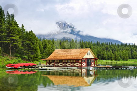 To use this stock image in your creative project, please select the size you need over to the right and click the "Add to Cart" button.
Your downloaded image will come with the Cutcaster watermark removed so don’t worry about the watermark you see on this page. Boathouse on mountain lake stock photo, Canoes at boathouse on Maligne Lake in Jasper National Park, Canada by Elena Elisseeva