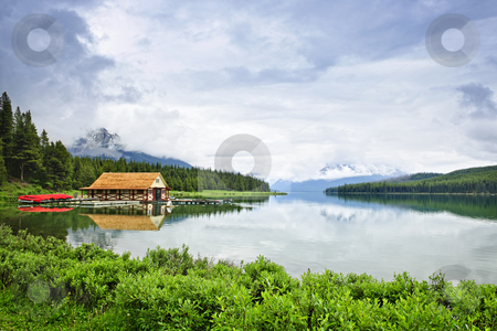 To use this stock image in your creative project, please select the size you need over to the right and click the "Add to Cart" button.
Your downloaded image will come with the Cutcaster watermark removed so don’t worry about the watermark you see on this page. Boathouse on mountain lake stock photo, Canoes at boathouse on Maligne Lake in Jasper National Park, Canada by Elena Elisseeva