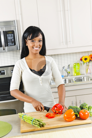 To use this stock image in your creative project, please select the size you need over to the right and click the "Add to Cart" button.
Your downloaded image will come with the Cutcaster watermark removed so don’t worry about the watermark you see on this page. Young woman cutting vegetables in kitchen stock photo, Smiling black woman cutting vegetables in modern kitchen interior by Elena Elisseeva