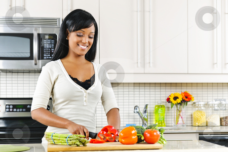 To use this stock image in your creative project, please select the size you need over to the right and click the "Add to Cart" button.
Your downloaded image will come with the Cutcaster watermark removed so don’t worry about the watermark you see on this page. Young woman cutting vegetables in kitchen stock photo, Smiling black woman cutting vegetables in modern kitchen interior by Elena Elisseeva