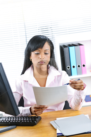 To use this stock image in your creative project, please select the size you need over to the right and click the "Add to Cart" button.
Your downloaded image will come with the Cutcaster watermark removed so don’t worry about the watermark you see on this page. Black businesswoman working at desk stock photo, Young black business woman reading document at desk in office by Elena Elisseeva