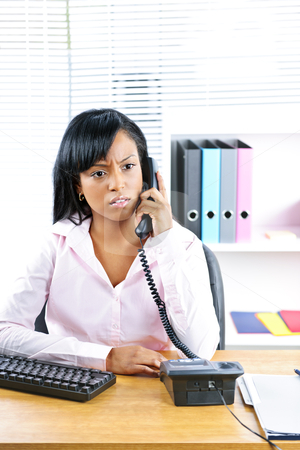 To use this stock image in your creative project, please select the size you need over to the right and click the "Add to Cart" button.
Your downloaded image will come with the Cutcaster watermark removed so don’t worry about the watermark you see on this page. Concerned black businesswoman on phone at desk stock photo, Concerned young black business woman on phone at desk in office by Elena Elisseeva