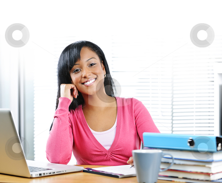 To use this stock image in your creative project, please select the size you need over to the right and click the "Add to Cart" button.
Your downloaded image will come with the Cutcaster watermark removed so don’t worry about the watermark you see on this page. Happy female student studying stock photo, Smiling young black female student with computer and textbooks at desk by Elena Elisseeva