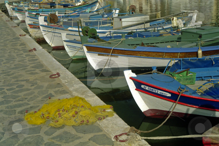 To use this stock image in your creative project, please select the size you need over to the right and click the "Add to Cart" button.
Your downloaded image will come with the Cutcaster watermark removed so don’t worry about the watermark you see on this page. Greek Fishing Boats stock photo, A Line of small Greek Fishing Boats on the quayside at Elounda Crete by d40xboy