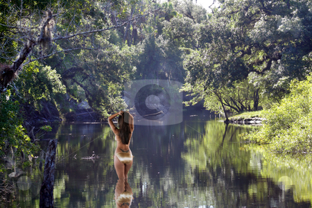 To use this stock image in your creative project, please select the size you need over to the right and click the "Add to Cart" button.
Your downloaded image will come with the Cutcaster watermark removed so don’t worry about the watermark you see on this page. Beautiful Latina Wading in a Tropical River stock photo, A lovely Latina wearing a striking gold bikini stands in a shallow, tropical river with her back to the camera. by Carl Stewart