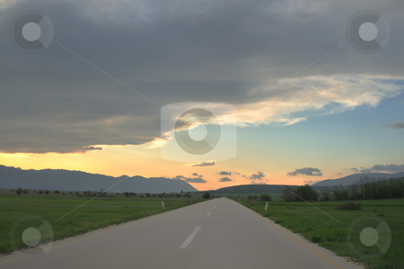 To use this stock image in your creative project, please select the size you need over to the right and click the "Add to Cart" button.
Your downloaded image will come with the Cutcaster watermark removed so don’t worry about the watermark you see on this page. Countryroad adventure with beautiful sunset stock photo, landscape in nature and countryroad adventure with beautiful sunset and dramatic clouds and sky by Benis Arapovic