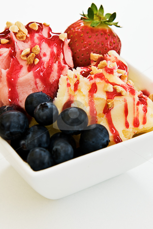 To use this stock image in your creative project, please select the size you need over to the right and click the "Add to Cart" button.
Your downloaded image will come with the Cutcaster watermark removed so don’t worry about the watermark you see on this page. Ice Cream Sundae stock photo, An ice cream sundae in a bowl. Made with vanilla and strawberry ice cream, blueberries, strawberries, waffles and strawberry topping. by thisboy